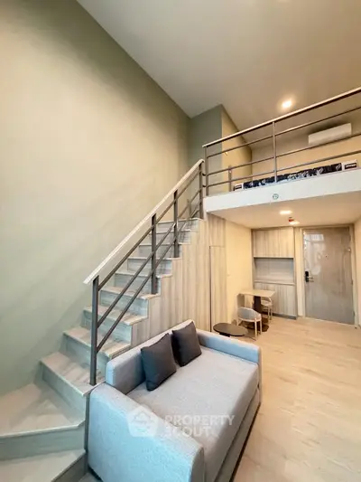 Modern loft apartment with stylish staircase and cozy living area