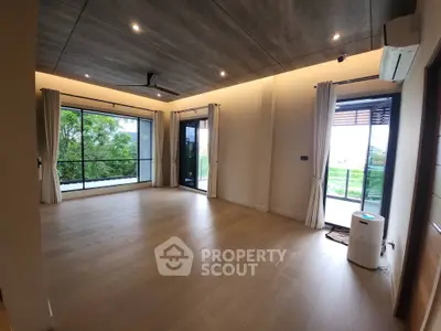 Spacious modern living room with large windows and scenic views