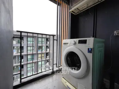 Modern apartment balcony with washing machine and city view, perfect for urban living convenience.