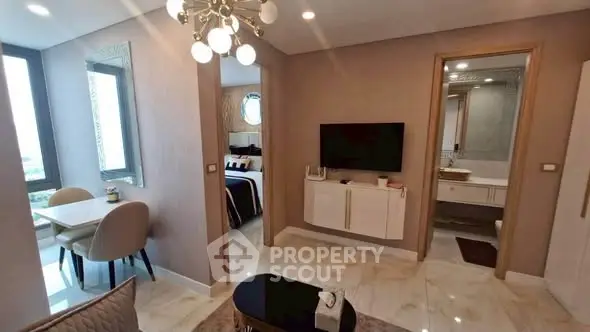 Modern apartment interior with stylish living room, dining area, and bedroom view.