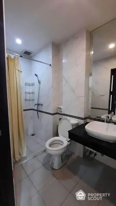 Modern bathroom with shower and sleek sink in real estate property