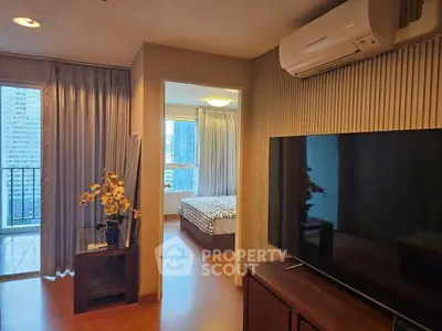 Modern apartment interior with TV, air conditioning, and balcony view