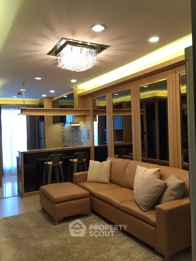 Luxurious living room with elegant lighting and modern decor in a stylish apartment.