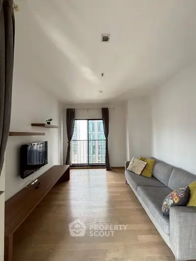 Modern living room with sleek design and city view balcony.