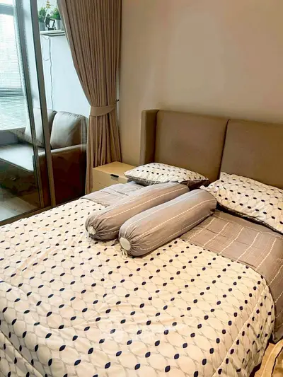 Cozy bedroom with modern decor and large window for natural light