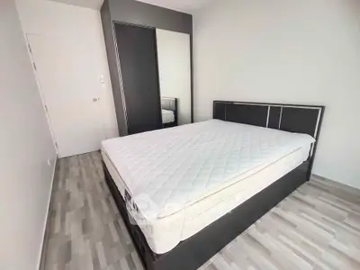 Modern minimalist bedroom with sleek furniture and natural light
