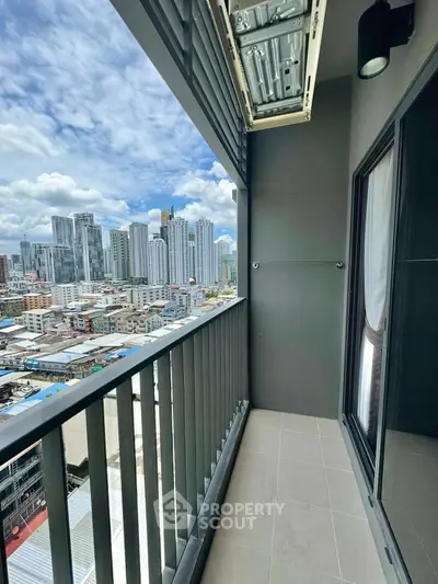 Stunning city view from modern high-rise balcony with sleek railing.