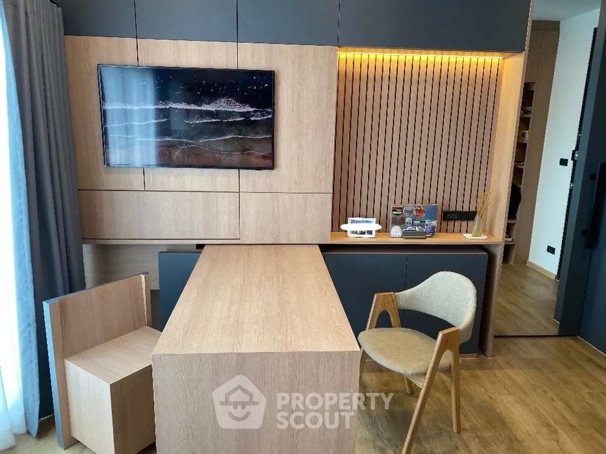 Modern study room with sleek wooden furniture and wall-mounted TV
