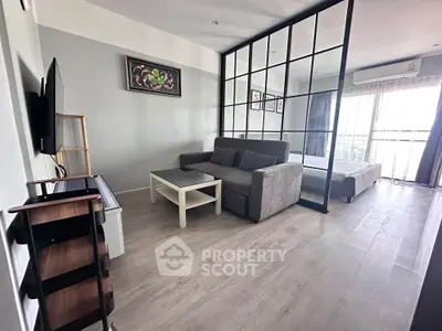 Modern studio apartment with stylish glass partition and cozy living area