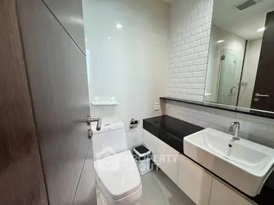Modern bathroom with sleek fixtures and white tile accents