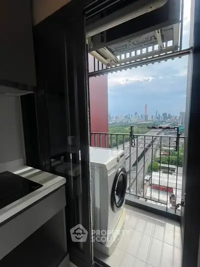 Modern apartment balcony with washing machine and stunning city skyline view.