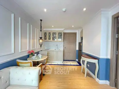 Charming small living room with elegant decor and compact kitchen area