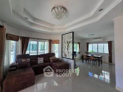 Spacious living room with elegant chandelier and modern decor
