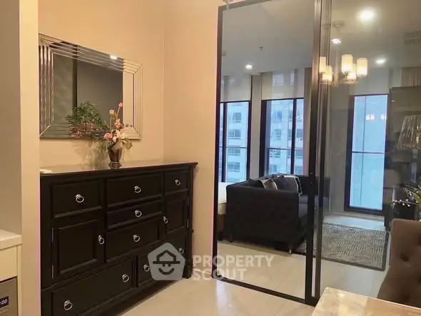 Stylish modern living room with elegant furniture and large windows in a chic apartment.