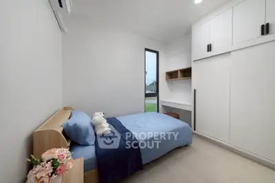 Modern minimalist bedroom with single bed and built-in storage