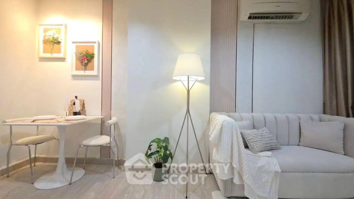 Chic living room with modern decor, cozy sofa, and elegant lighting.