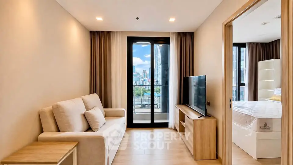 Modern living room with city view, featuring cozy sofa and sleek TV setup.