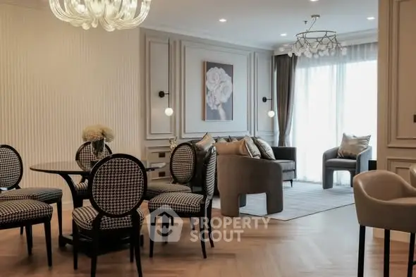 Elegant living room with stylish furniture and modern decor, featuring a cozy seating area and chic dining set.