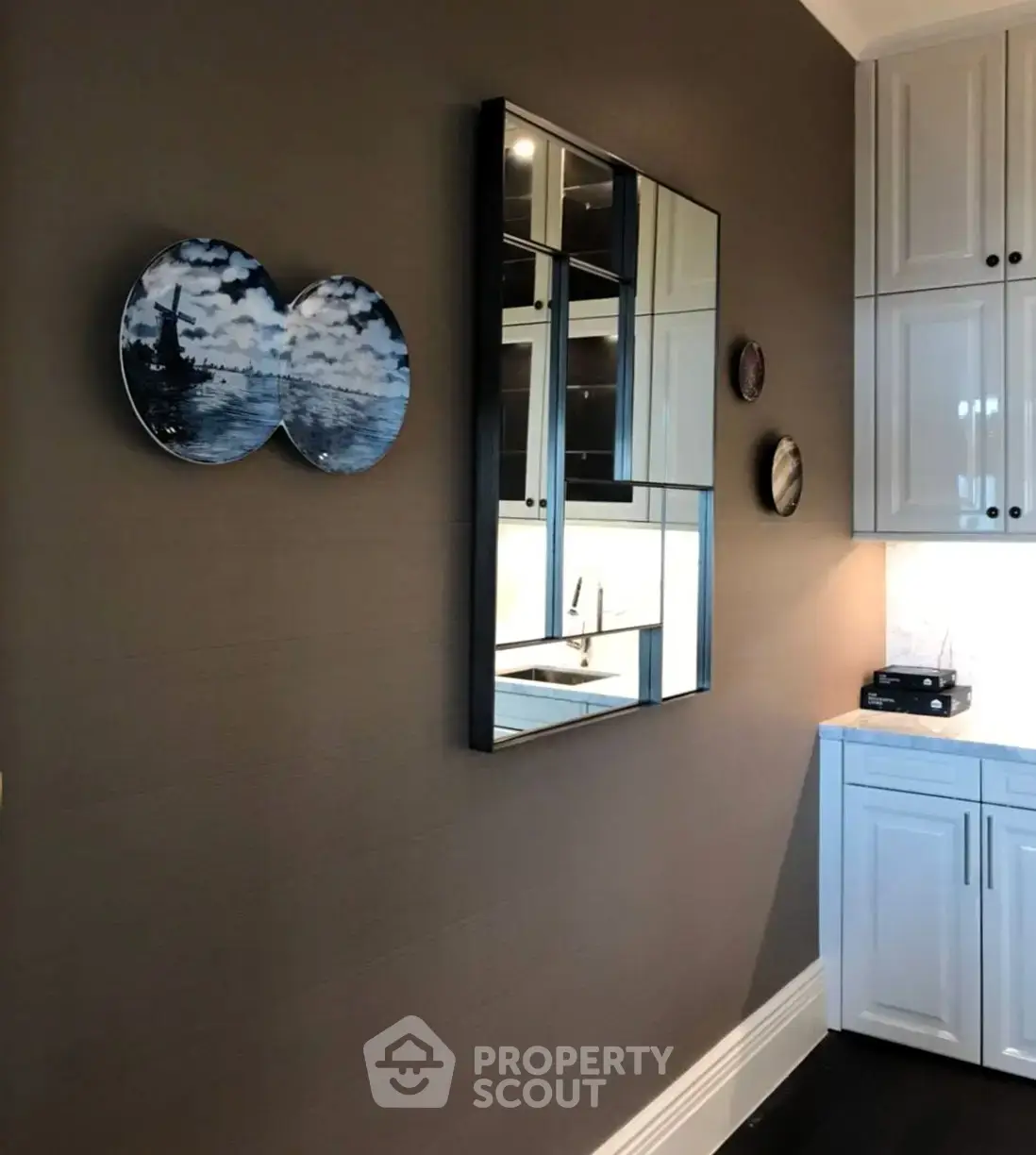 Modern kitchen with sleek cabinetry and artistic wall decor