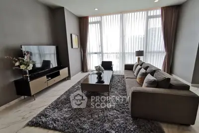 Spacious modern living room with large windows and elegant decor