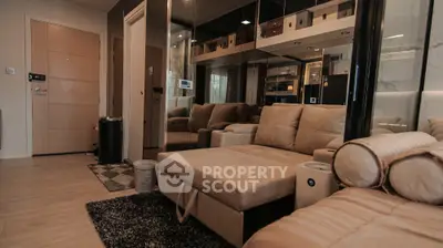 Modern living room with stylish beige sofa and mirrored wall