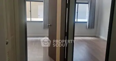 Spacious modern apartment with two bright rooms and large windows.