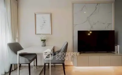Modern living room with elegant dining set and sleek TV unit, featuring stylish decor and natural light.