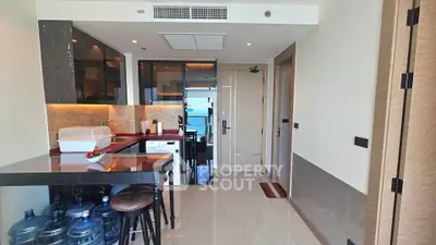 Modern kitchen with sleek design and ocean view, featuring high-end appliances and stylish decor.