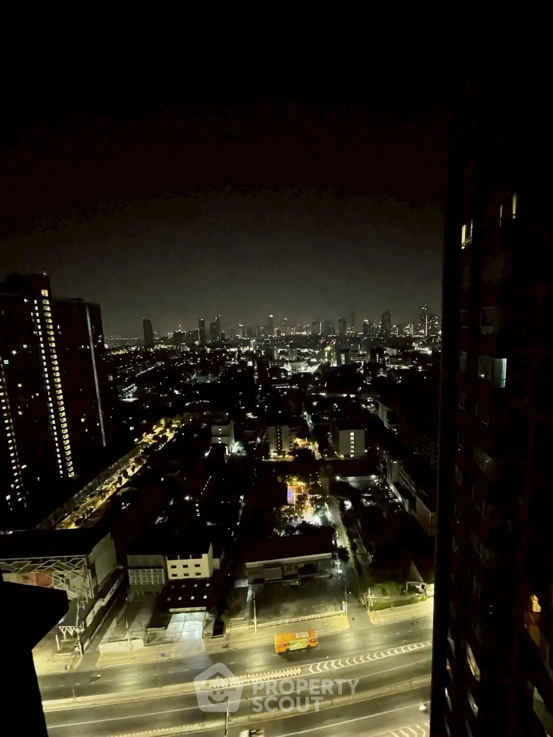 Stunning cityscape night view from high-rise building, showcasing vibrant urban lights and skyline.