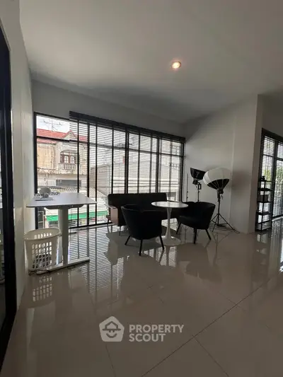 Spacious modern living room with large windows and sleek furniture