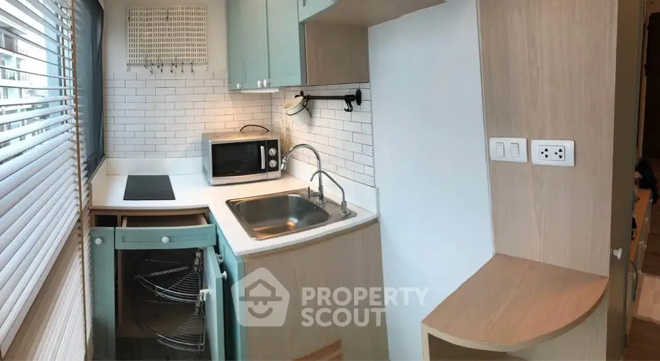 Compact kitchen with modern appliances and sleek design