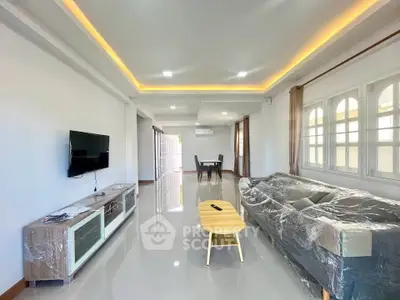 Spacious modern living room with sleek design and natural light, perfect for relaxation and entertainment.