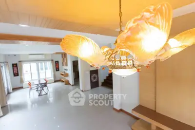 Spacious living room with elegant chandelier and modern decor