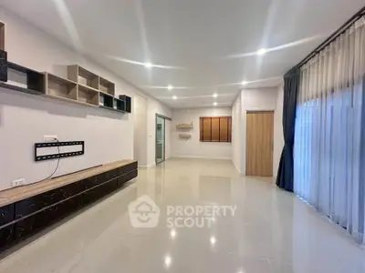 Spacious modern living room with sleek shelving and large windows