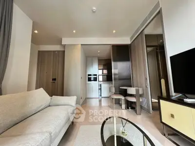 Modern living room with sleek furniture and open kitchen layout in a stylish apartment.