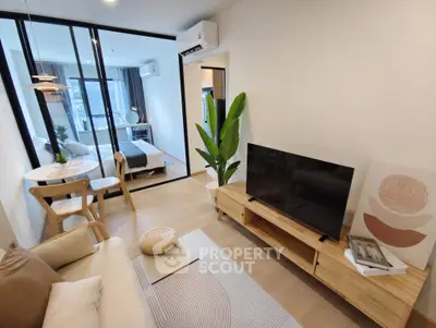 Modern living room with stylish decor and open view to bedroom