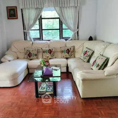 Cozy living room with plush sectional sofa and elegant decor, perfect for relaxation and entertaining.