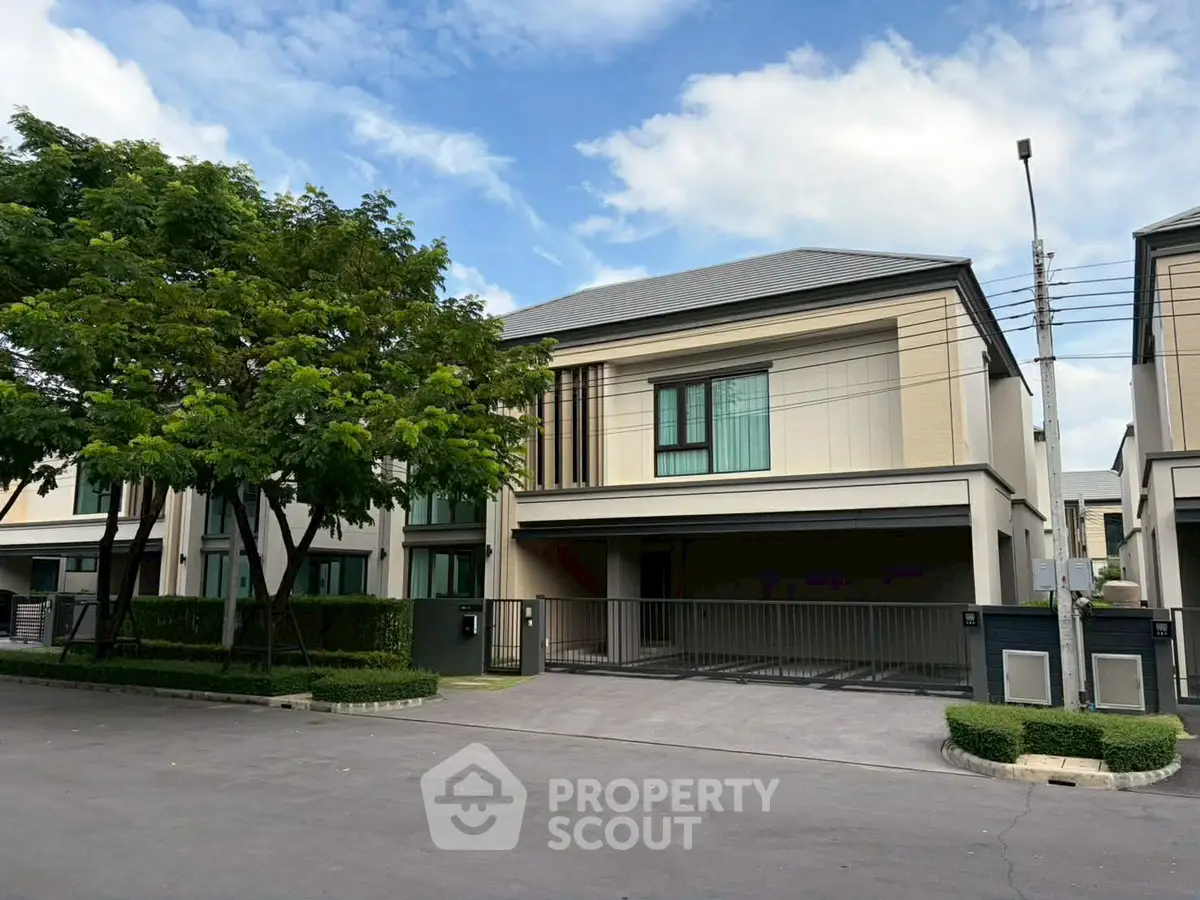 Modern two-story house with spacious driveway and lush greenery