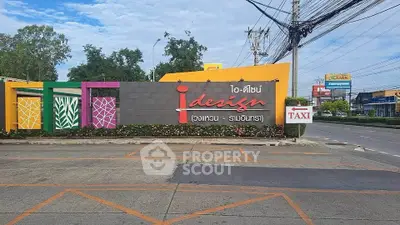 Colorful entrance sign of iDesign residential community with vibrant design elements.