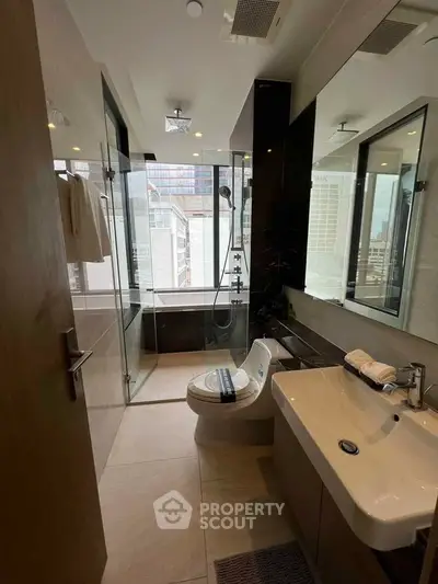Luxurious modern bathroom with city view, featuring sleek fixtures and glass shower enclosure.