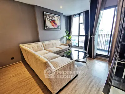 Modern living room with stylish sofa and balcony view in urban apartment