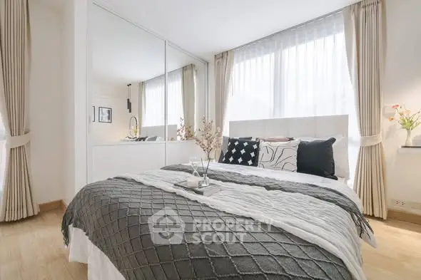 Elegant bedroom with large mirrored wardrobe and stylish decor