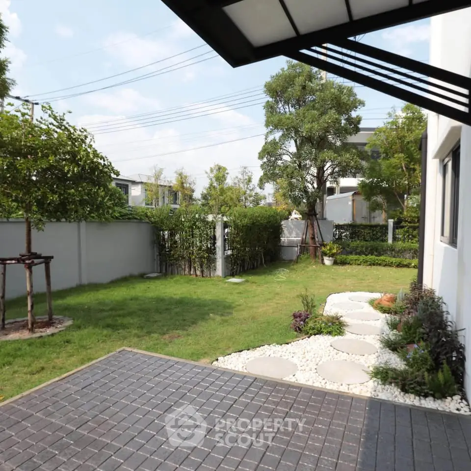 Charming backyard with lush greenery and modern landscaping in a serene residential area.