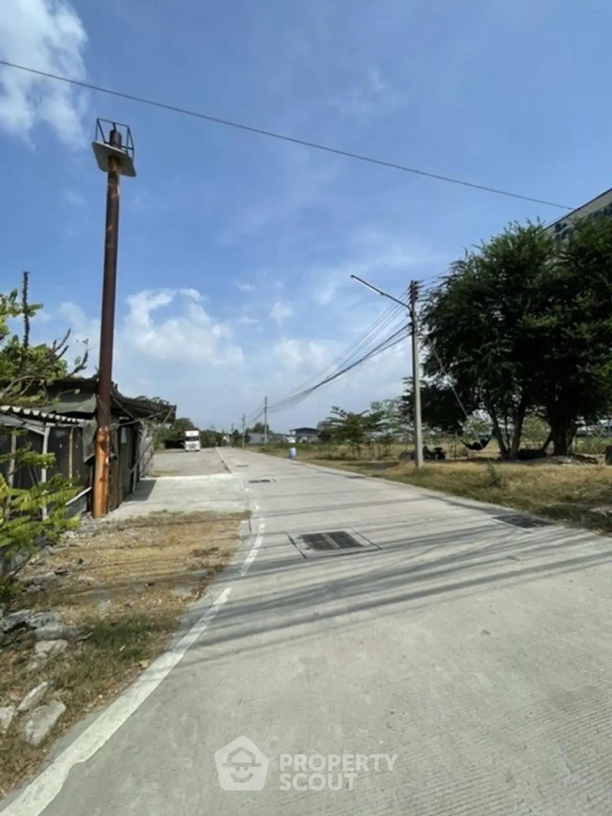 Scenic view of a quiet residential street with clear blue skies.