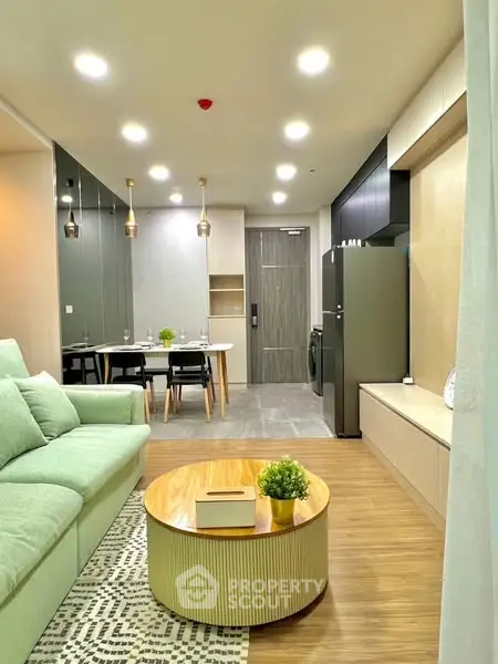 Modern living room with stylish furniture and open dining area