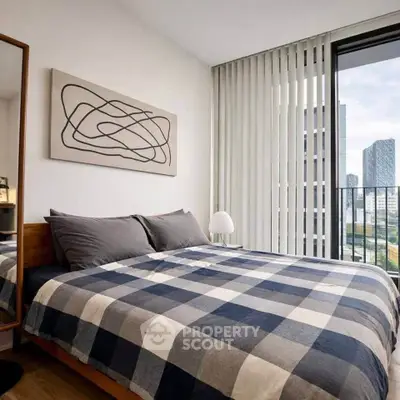 Modern bedroom with stylish decor and city view from balcony, featuring a cozy bed and contemporary art.