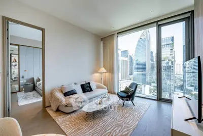 Luxurious living room with stunning city view, modern furniture, and floor-to-ceiling windows in a high-rise apartment.