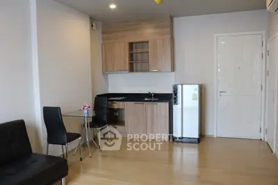 Modern studio apartment with compact kitchen and stylish furnishings