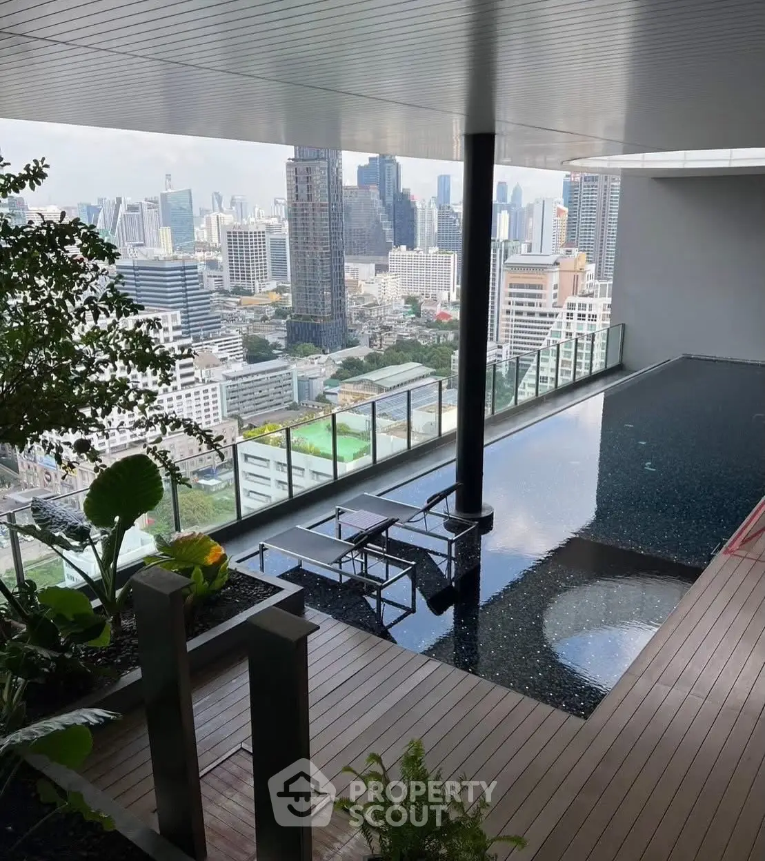 Luxurious rooftop pool with stunning city skyline view, perfect for urban living enthusiasts.