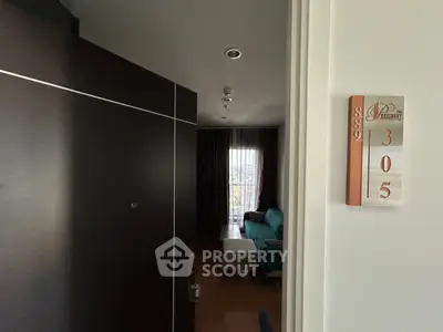 Modern apartment entrance with stylish door and cozy living room view